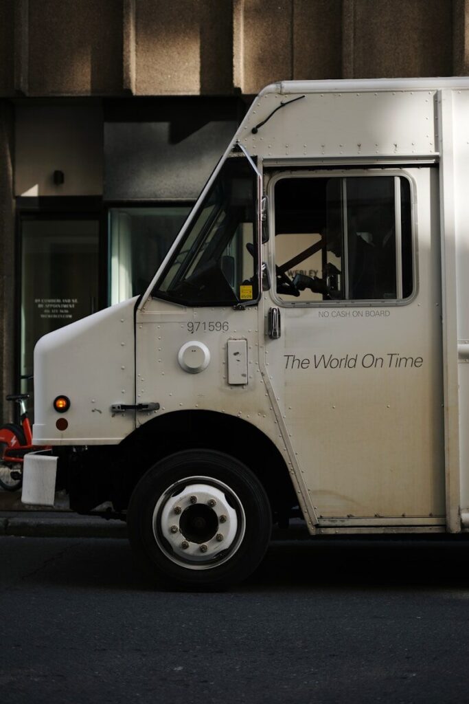White delivery truck with "the world on time" text.